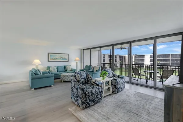 a living room with furniture window and wooden floor
