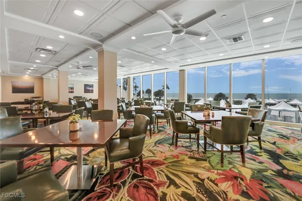 a dining room with large glass table and chairs