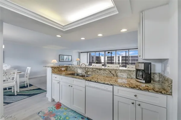 a kitchen with sink stove and cabinets