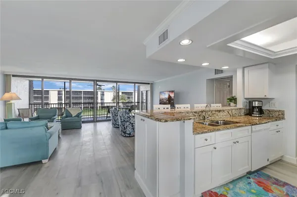 a large kitchen with a table and chairs