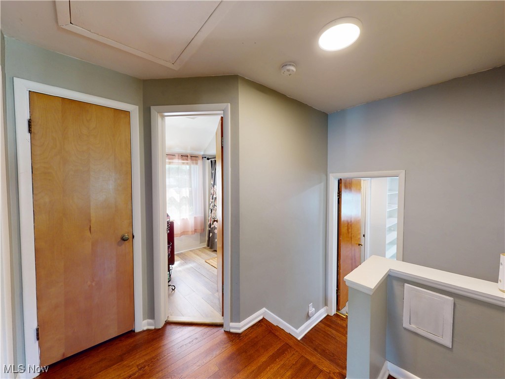 1025 Professor Road Cleveland, OH 44124 - Photo 24 of 34 Hall featuring dark wood-style floors, baseboards, and an upstairs landing