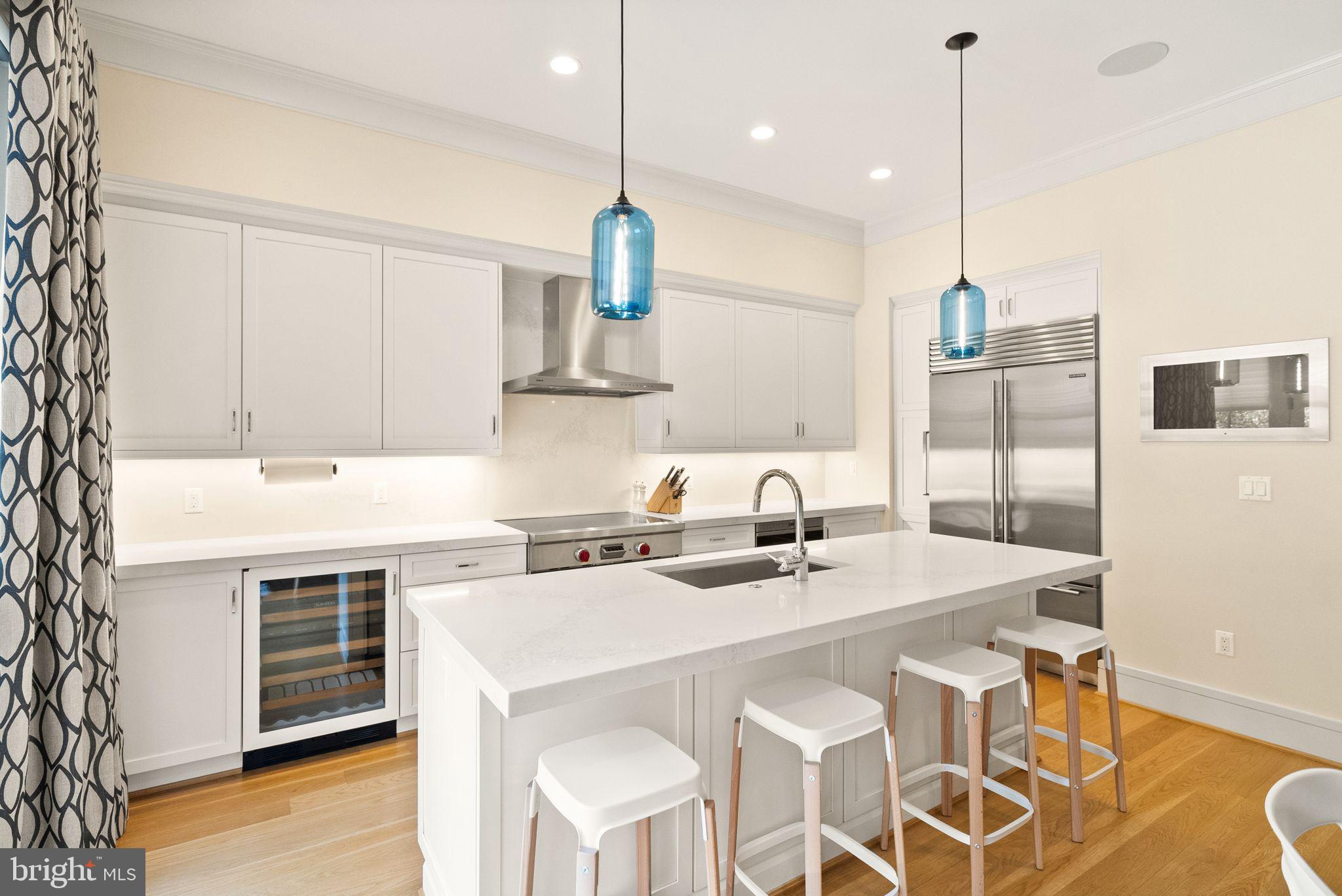 424 3rd Street Northeast Washington, DC 20002 - Photo 11 of 33 a kitchen with a sink a stove a dining table and chairs