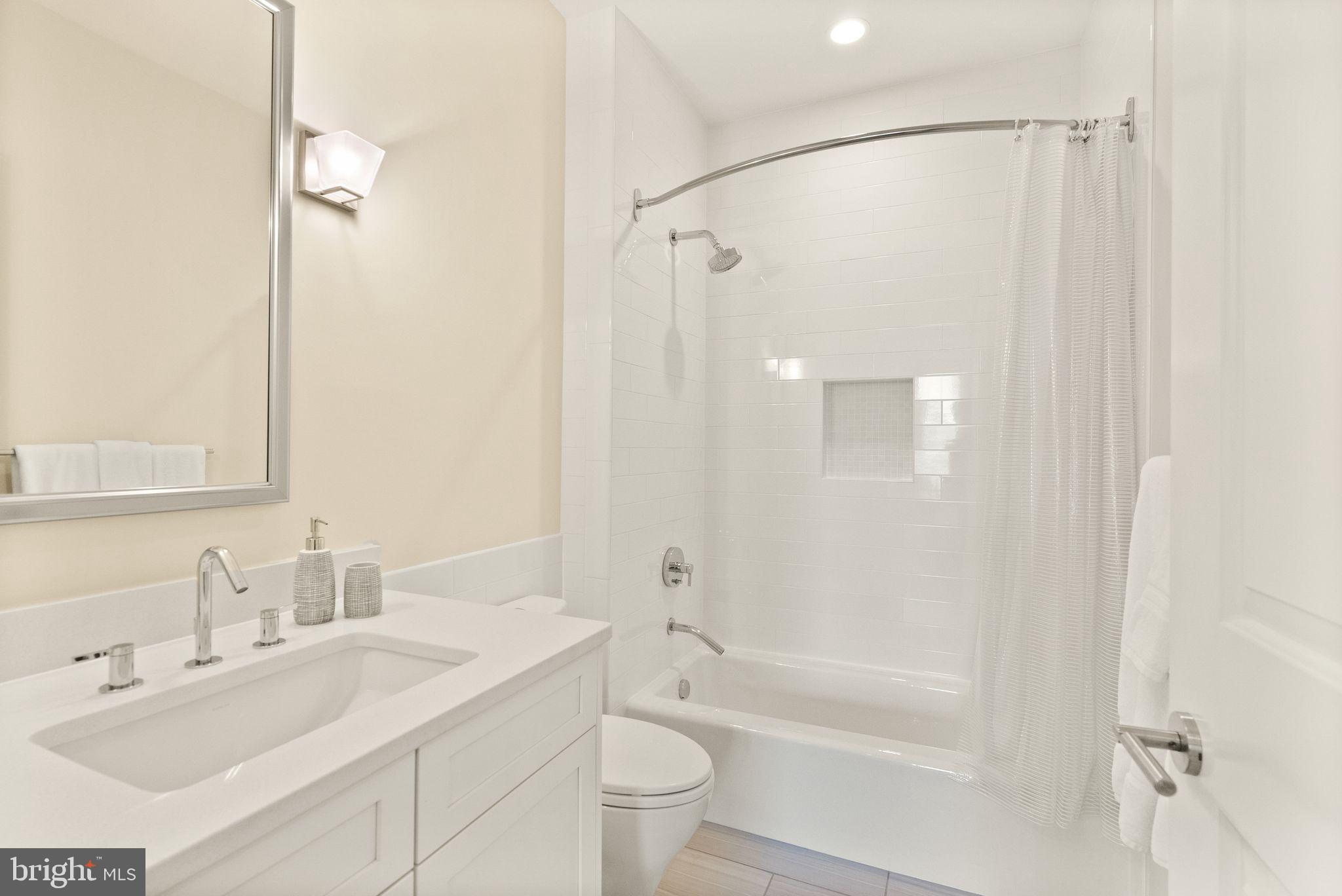 424 3rd Street Northeast Washington, DC 20002 - Photo 26 of 33 a bathroom with a bathtub shower sink vanity and toilet