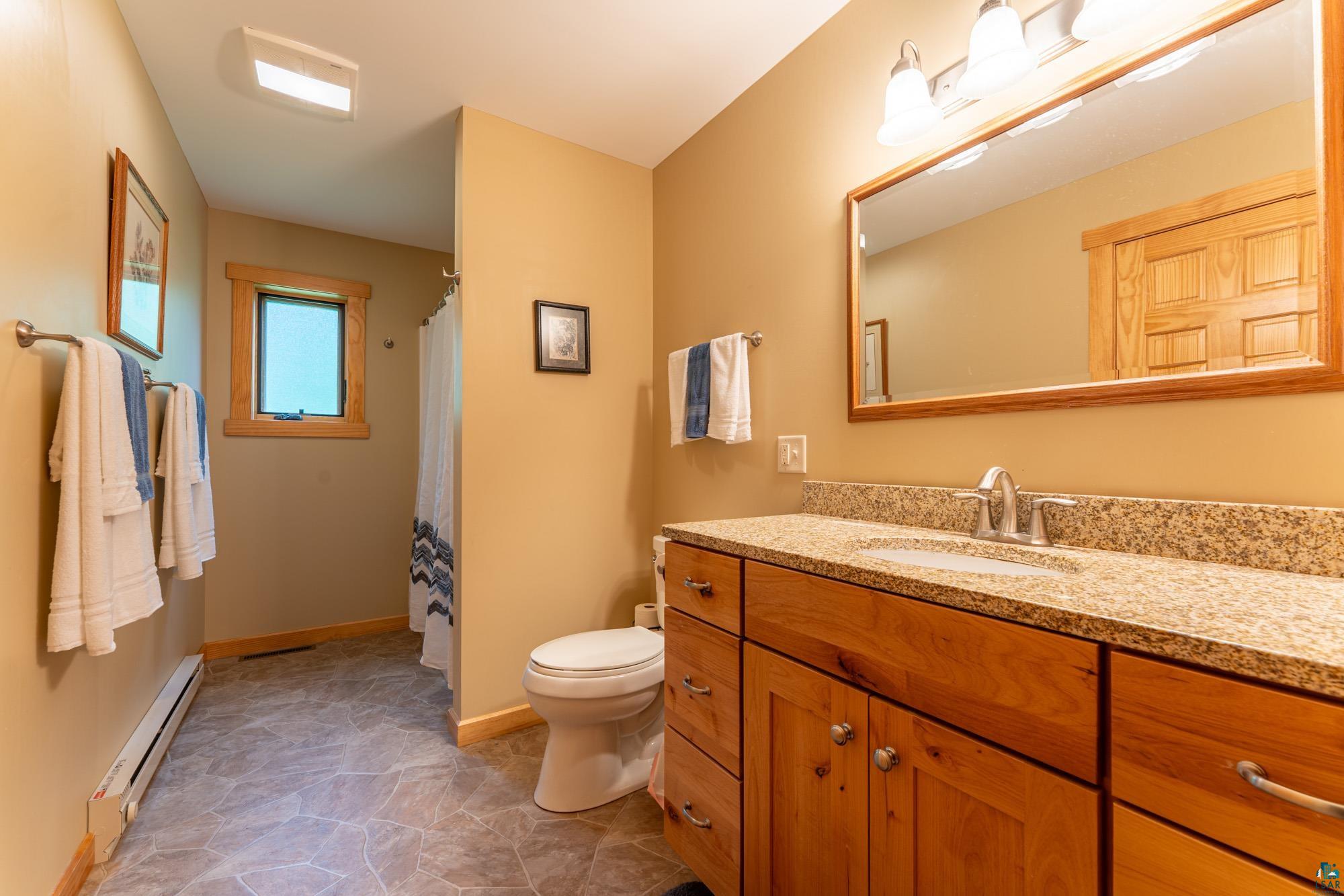 1663 Saari Road Ely, MN 55731 - Photo 14 of 31 Full bathroom featuring vanity and a baseboard radiator