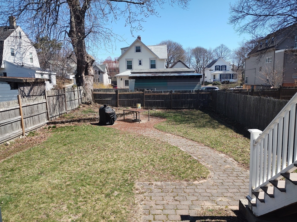 41 Webber Street, Unit 1 Malden, MA 02148 - Photo 20 of 22 a view of a back yard with a table and chair