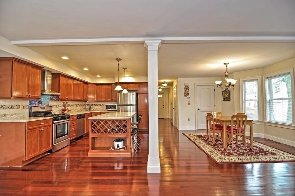 41 Webber Street, Unit 1 Malden, MA 02148 - Photo 3 of 22 a large kitchen with a table and chairs