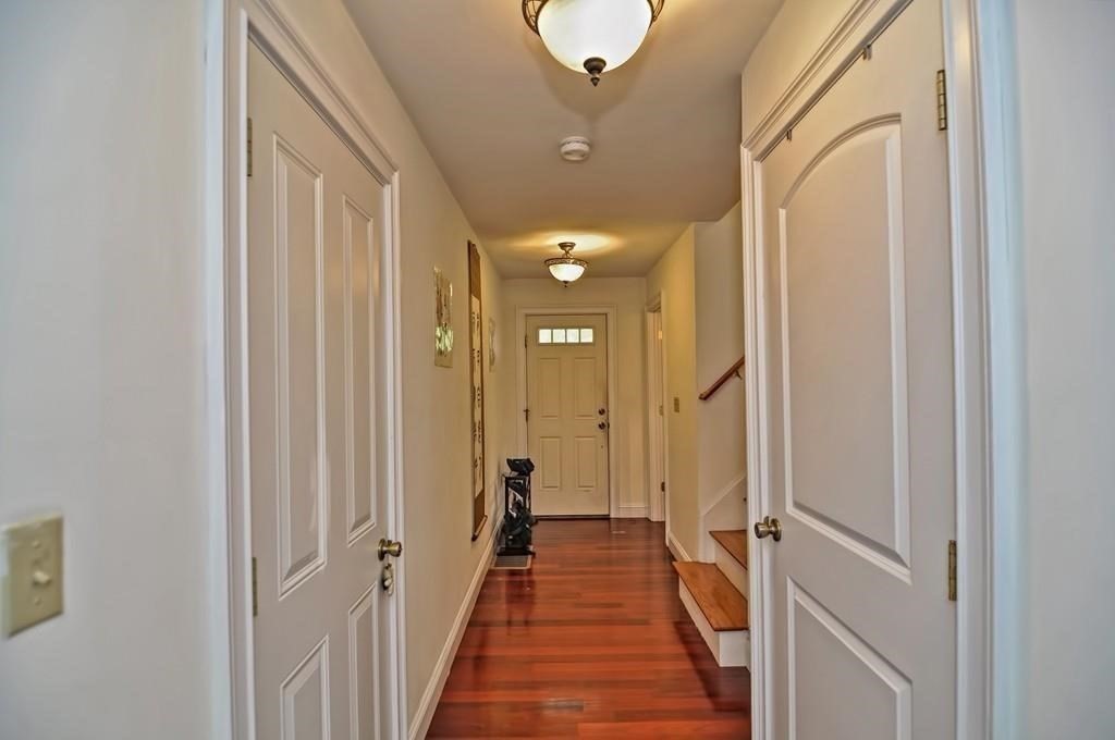 41 Webber Street, Unit 1 Malden, MA 02148 - Photo 5 of 22 a view of a hallway with wooden floor and a bathroom
