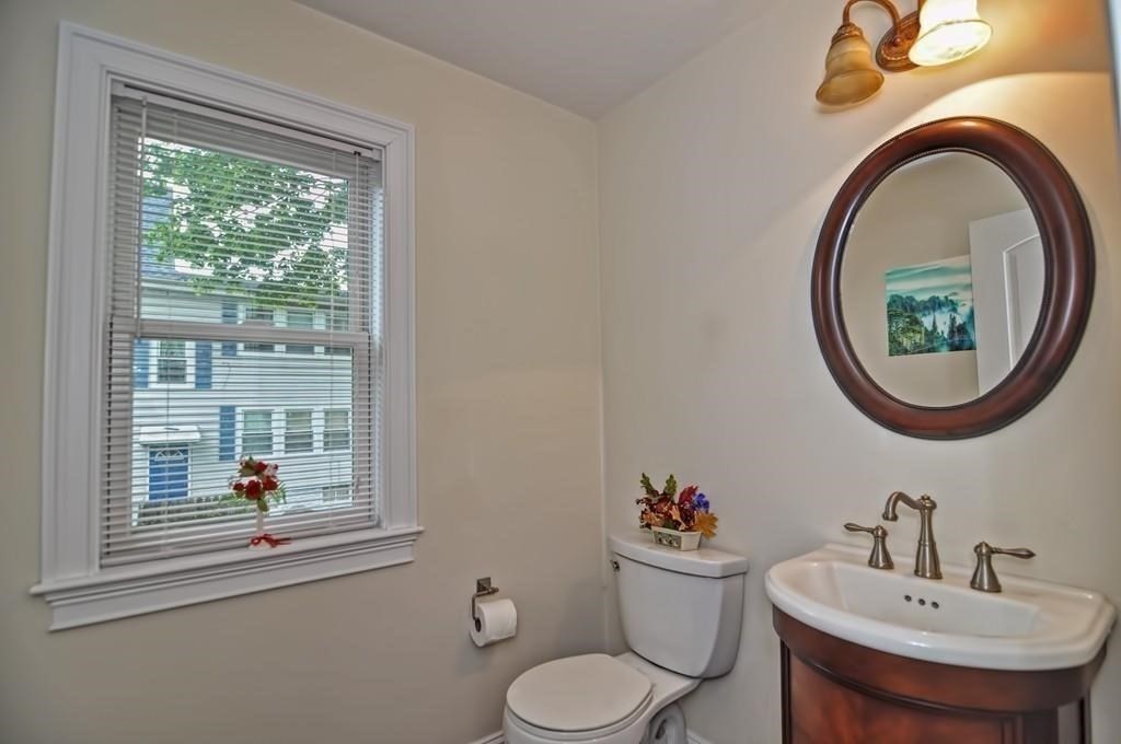 41 Webber Street, Unit 1 Malden, MA 02148 - Photo 6 of 22 a bathroom with a toilet sink and mirror