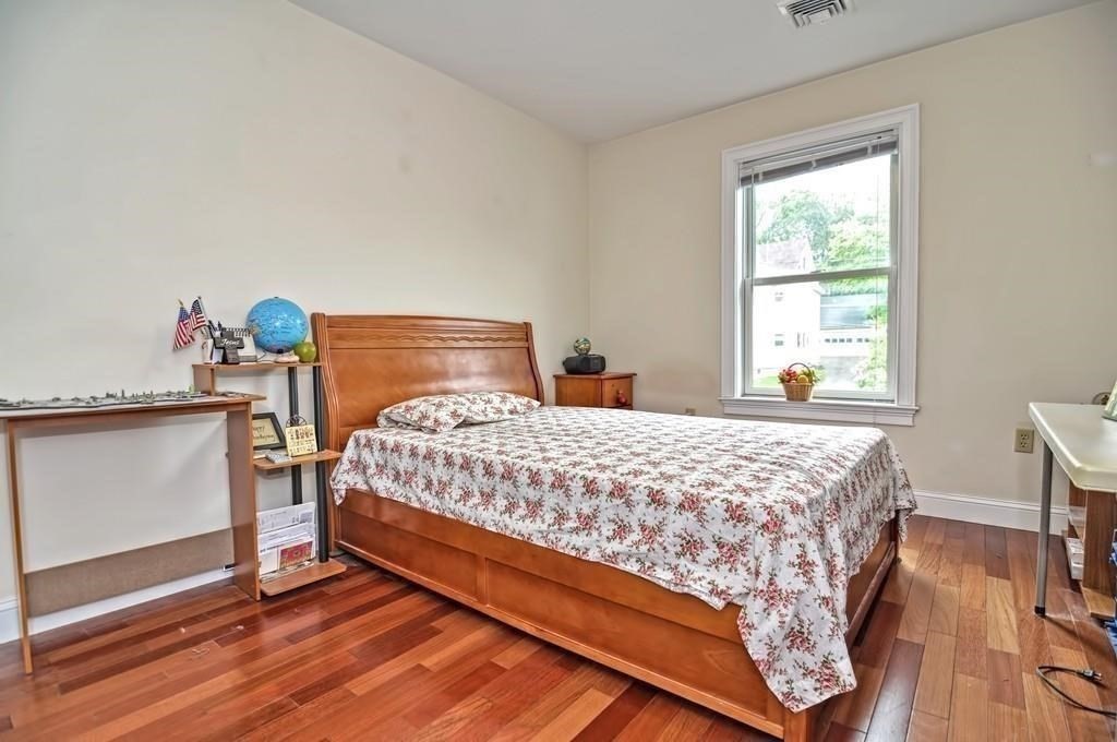 41 Webber Street, Unit 1 Malden, MA 02148 - Photo 8 of 22 a bed sitting in a bedroom next to a window