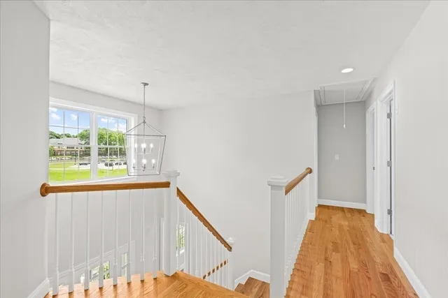 a view of a room with wooden floor and windows