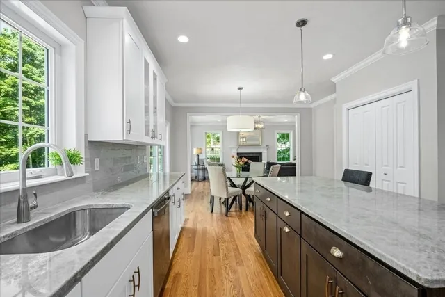 a kitchen with sink cabinets and wooden floor