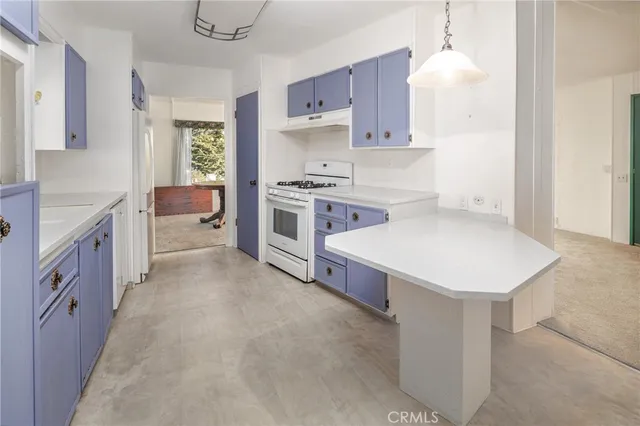 a kitchen with a stove sink and cabinets