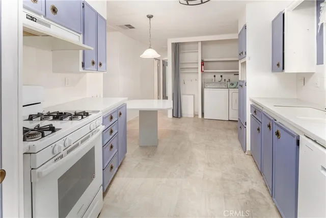 a kitchen with stainless steel appliances granite countertop a stove and a refrigerator