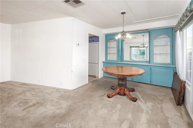 a view of a kitchen with a sink and a chandelier