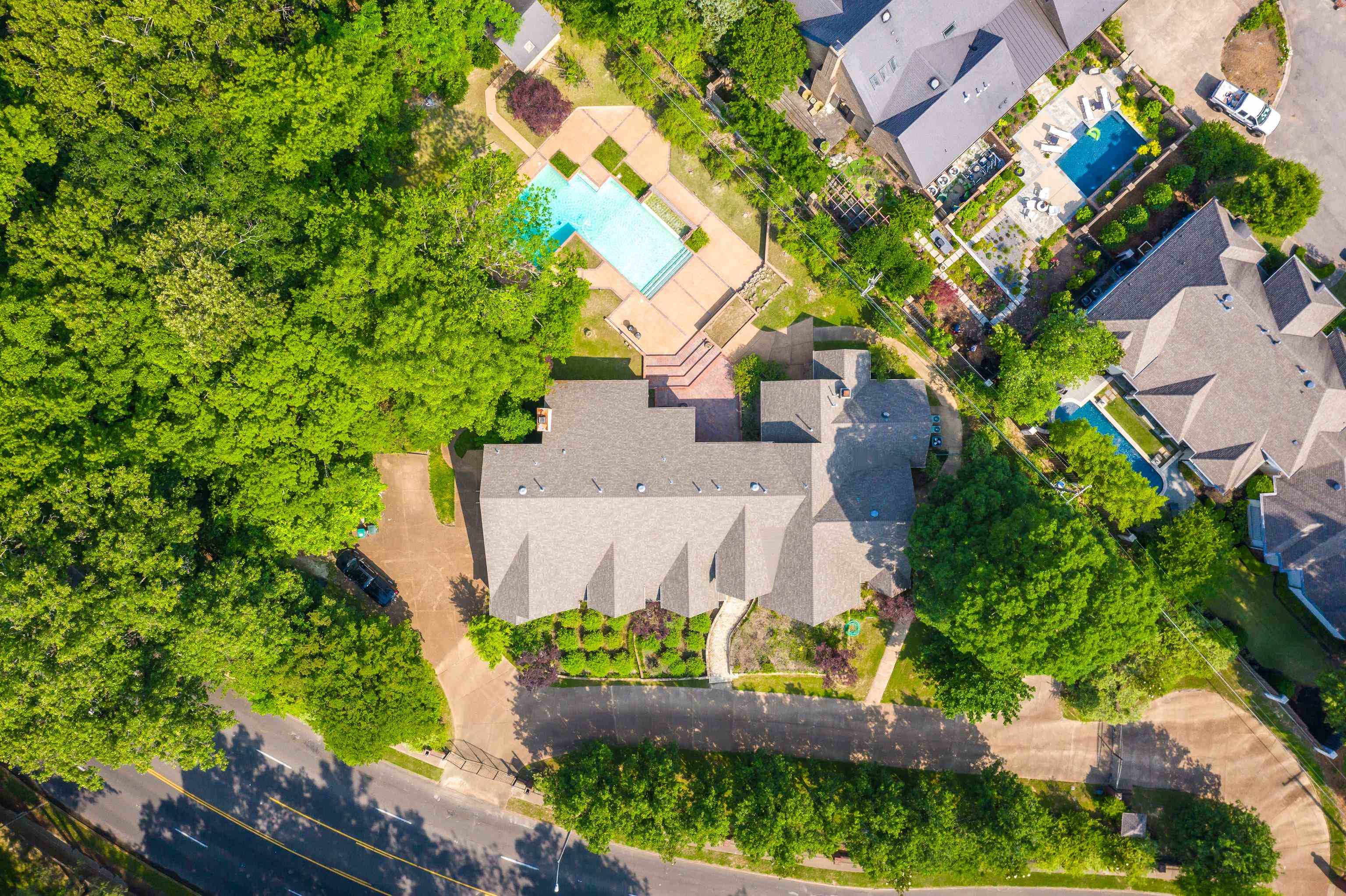 an aerial view of a house with a yard and a large tree