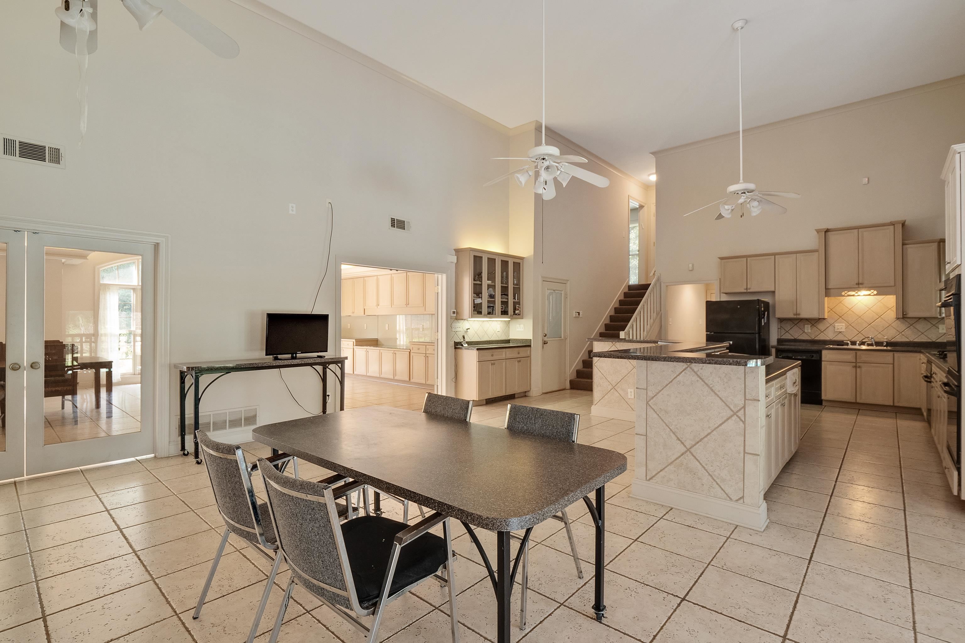 5270 Walnut Grove Road Memphis, TN 38120 - Photo 17 of 25 a kitchen with stainless steel appliances kitchen island granite countertop a table chairs and a refrigerator