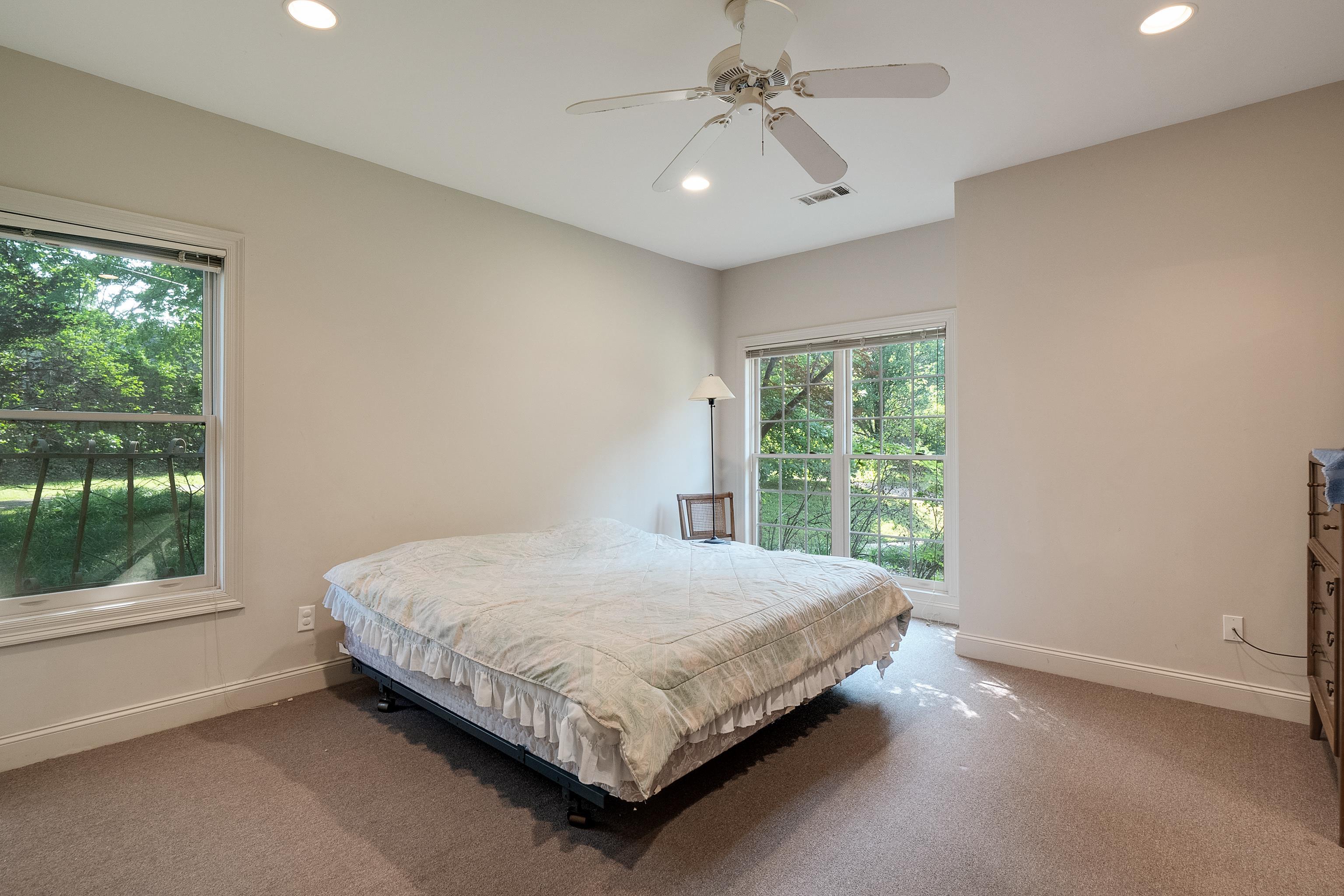 5270 Walnut Grove Road Memphis, TN 38120 - Photo 23 of 25 a bed sitting in a spacious bedroom next to a window