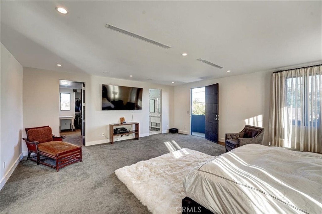 2012 South Curson Avenue Los Angeles, CA 90016 - Photo 14 of 40 a spacious bedroom with a bed and a flat screen television