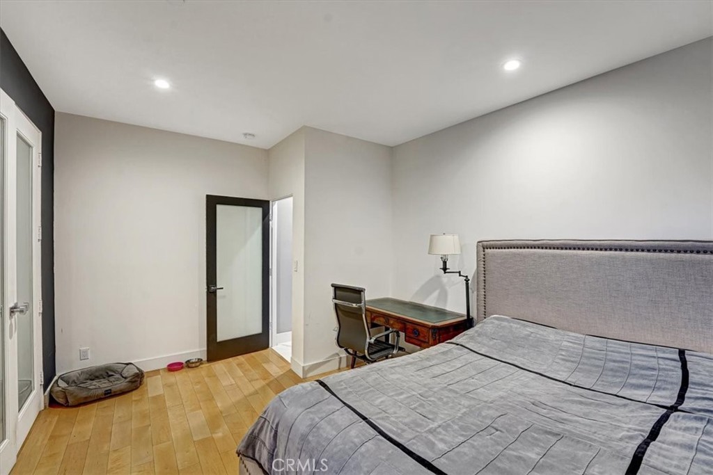 2012 South Curson Avenue Los Angeles, CA 90016 - Photo 17 of 40 a bedroom with a bed and a large mirror