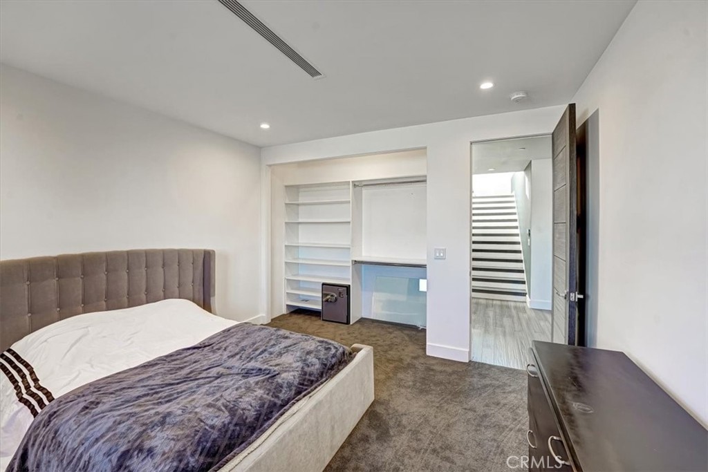 2012 South Curson Avenue Los Angeles, CA 90016 - Photo 19 of 40 a bedroom with a large bed and a chandelier