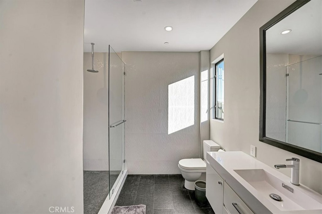 2012 South Curson Avenue Los Angeles, CA 90016 - Photo 25 of 40 a bathroom with a sink a toilet and a large mirror