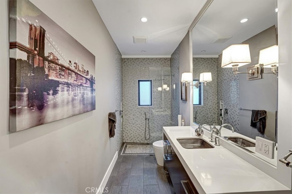 2012 South Curson Avenue Los Angeles, CA 90016 - Photo 29 of 40 a bathroom with a double vanity sink mirror and bathtub
