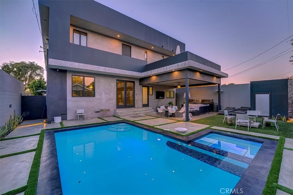 2012 South Curson Avenue Los Angeles, CA 90016 - Photo 37 of 40 a view of a backyard with table and chairs under an umbrella