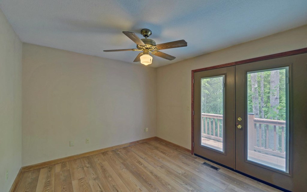 1720 Caney Creek Road Murphy, NC 28906 - Photo 11 of 69 an empty room with wooden floor and windows