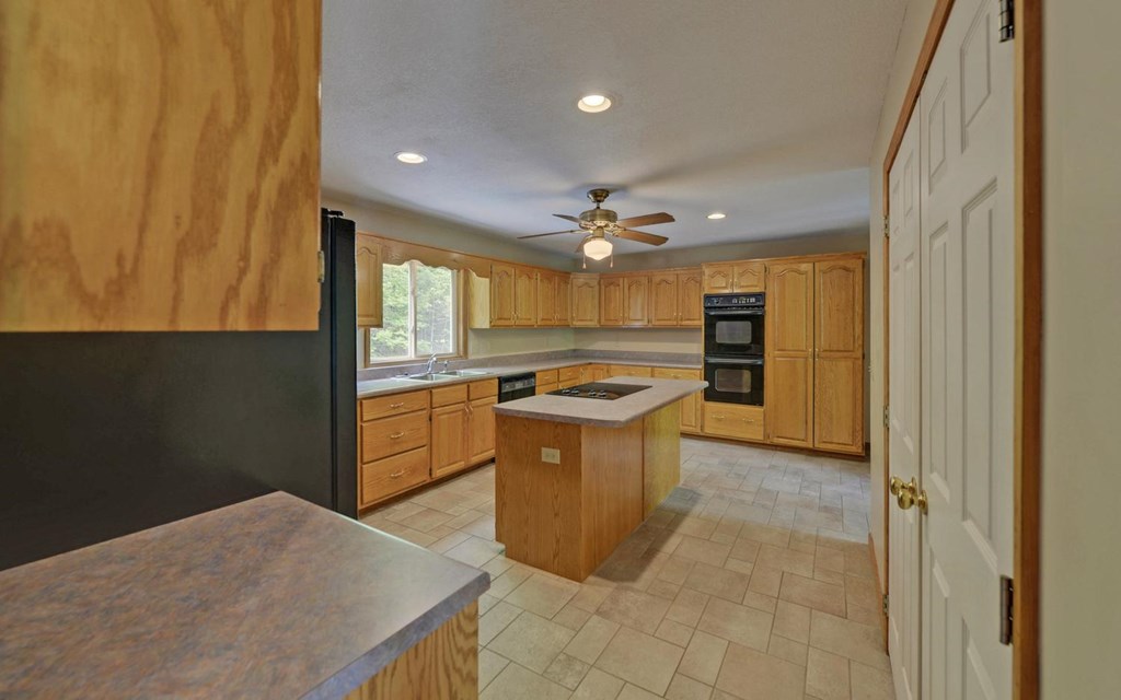 1720 Caney Creek Road Murphy, NC 28906 - Photo 15 of 69 a kitchen with stainless steel appliances granite countertop a sink and a refrigerator