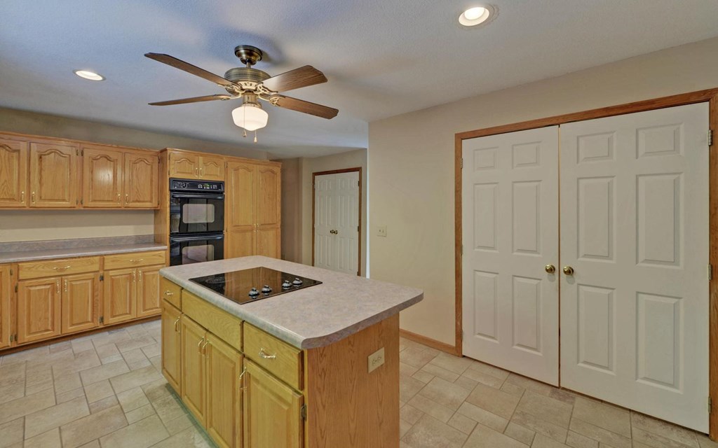 1720 Caney Creek Road Murphy, NC 28906 - Photo 16 of 69 a kitchen that has a lot of cabinets in it and wooden cabinets