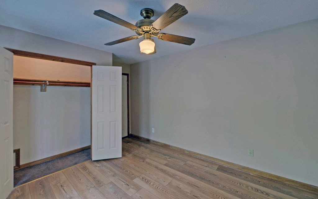 1720 Caney Creek Road Murphy, NC 28906 - Photo 29 of 69 an empty room with wooden floor and a ceiling fan