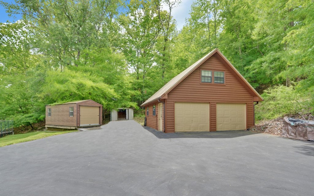 1720 Caney Creek Road Murphy, NC 28906 - Photo 55 of 69 a view of an house with backyard and bushes