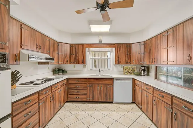 a kitchen with stainless steel appliances granite countertop a sink and cabinets