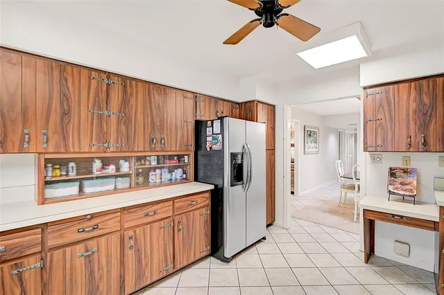 a kitchen with granite countertop a refrigerator a stove a sink and dishwasher
