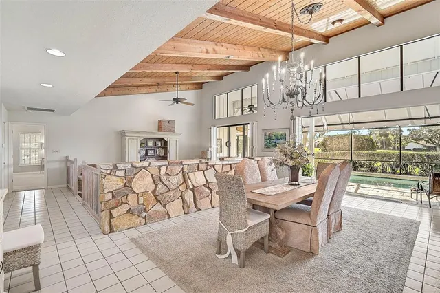 a view of a dining room with furniture large windows and wooden floor