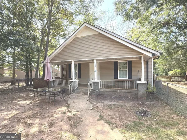 a front view of house with yard and outdoor seating
