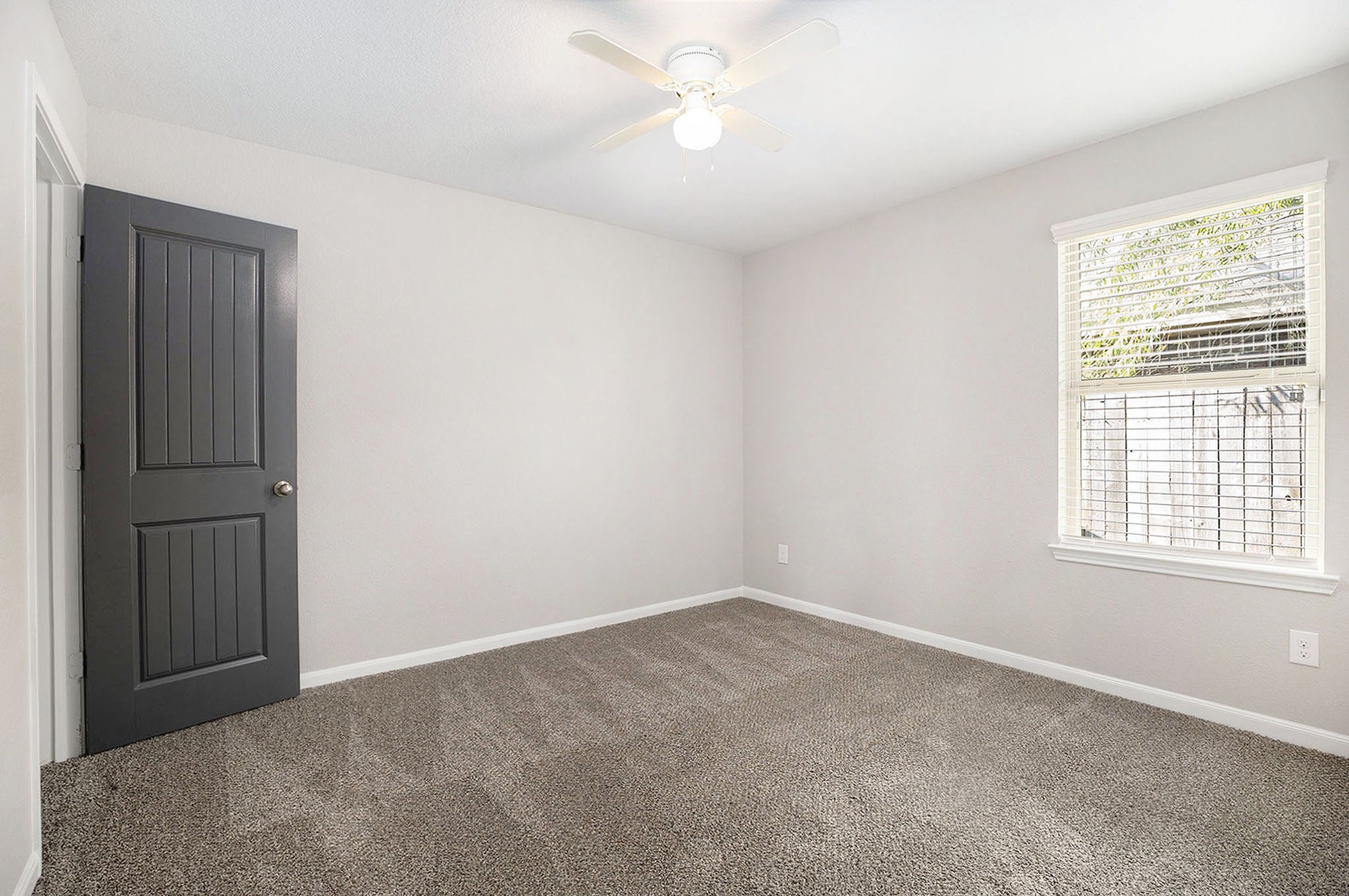 4027 Spurwing Lane Baytown, TX 77521 - Photo 17 of 34 This secondary bedroom features new paint and new carpet. A large window provides natural light.