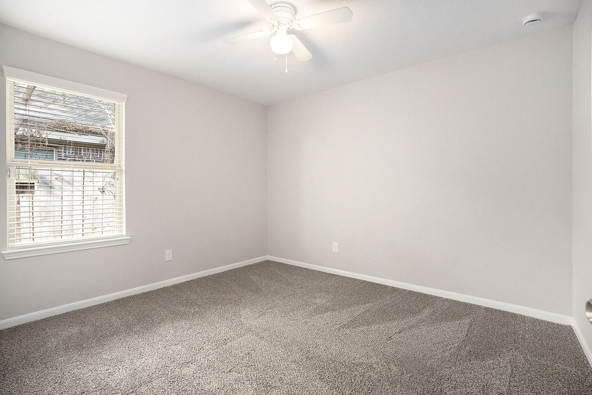 4027 Spurwing Lane Baytown, TX 77521 - Photo 18 of 34 This secondary bedroom features new paint and new carpet. A large window provides natural light.