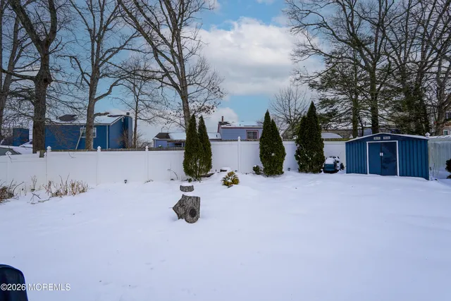 a living room with furniture fireplace and a large window