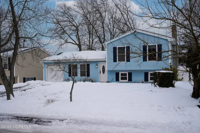 a view of a house with a yard covered in snow