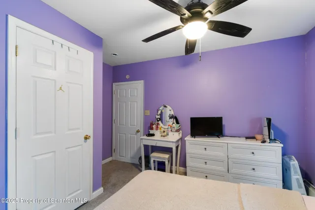 a bedroom with furniture and a large window