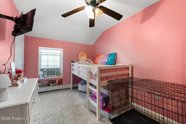 a bedroom with a bed and a fan