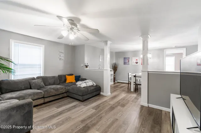 a living room with furniture and a flat screen tv