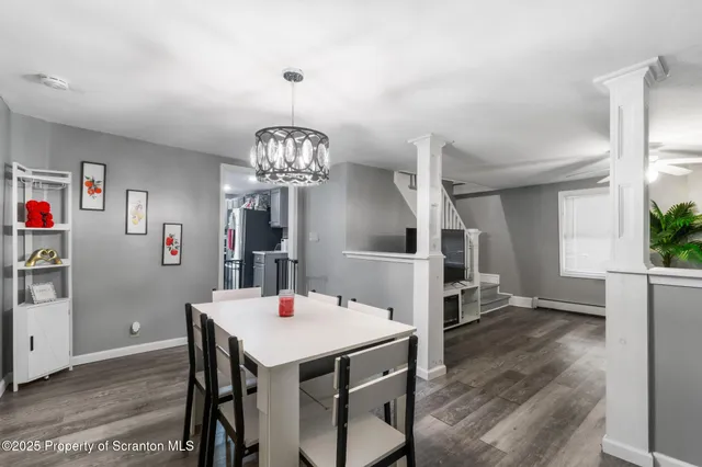 a view of a dining room with furniture and chandelier