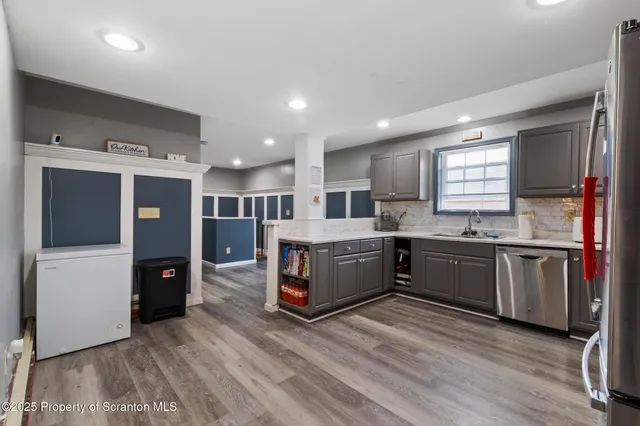 a kitchen with stainless steel appliances granite countertop a refrigerator sink and cabinets