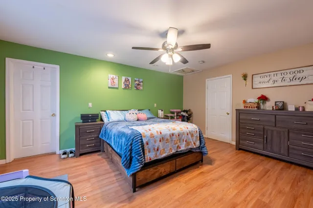 a bedroom with a bed and a chandelier
