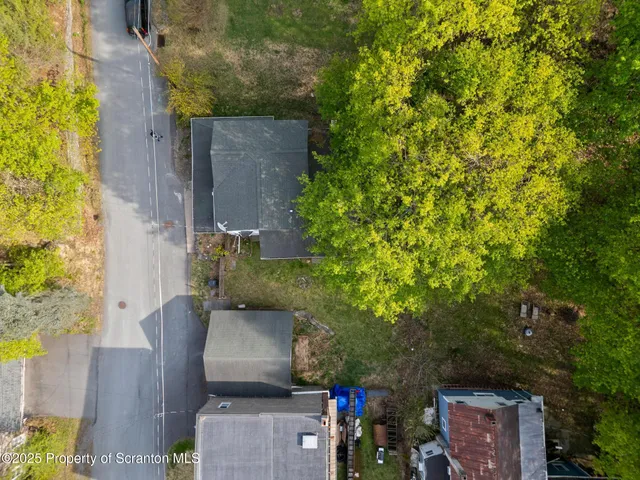 a view of a white house with a yard
