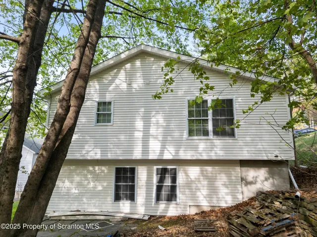 a view of house with backyard and garden
