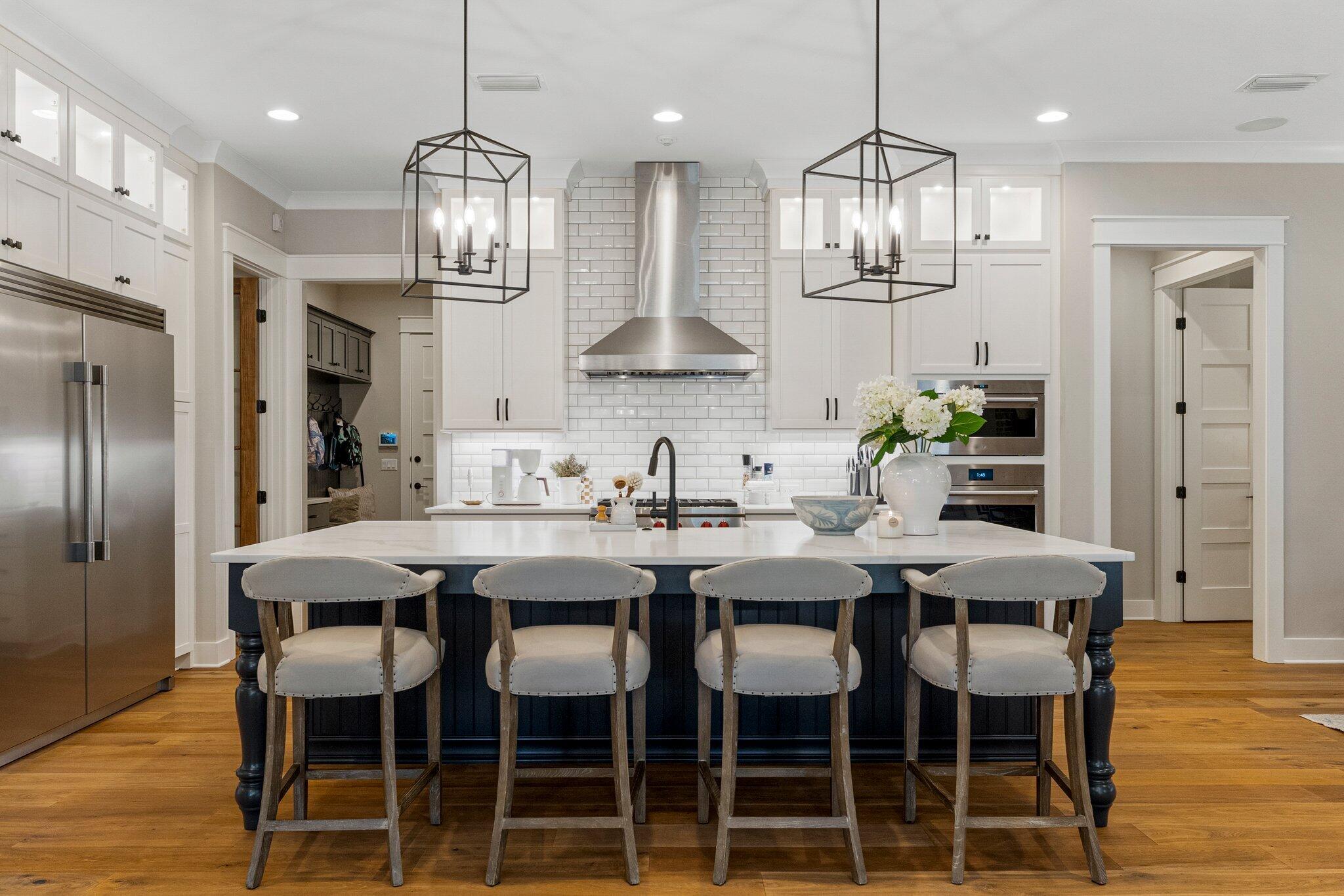 207 Pheasant Way Road Santa Rosa Beach, FL 32459 - Photo 21 of 70 a kitchen with stainless steel appliances kitchen island granite countertop a dining table chairs and white cabinets
