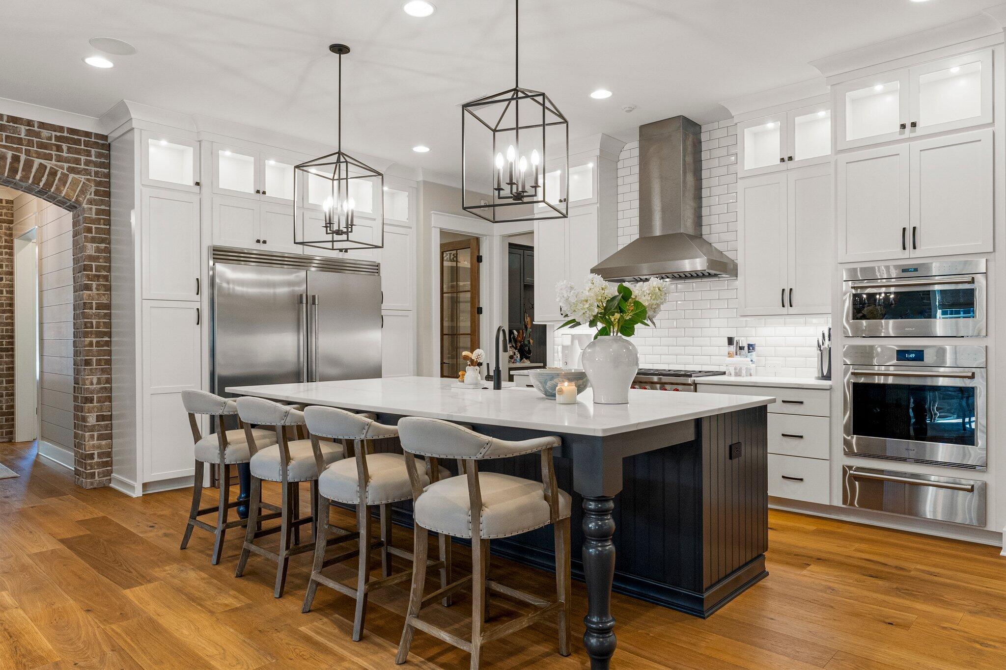207 Pheasant Way Road Santa Rosa Beach, FL 32459 - Photo 22 of 70 a kitchen with stainless steel appliances kitchen island granite countertop a kitchen island a stove a table a sink and a refrigerator